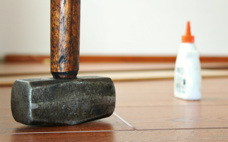 hammer and glue on floorboards